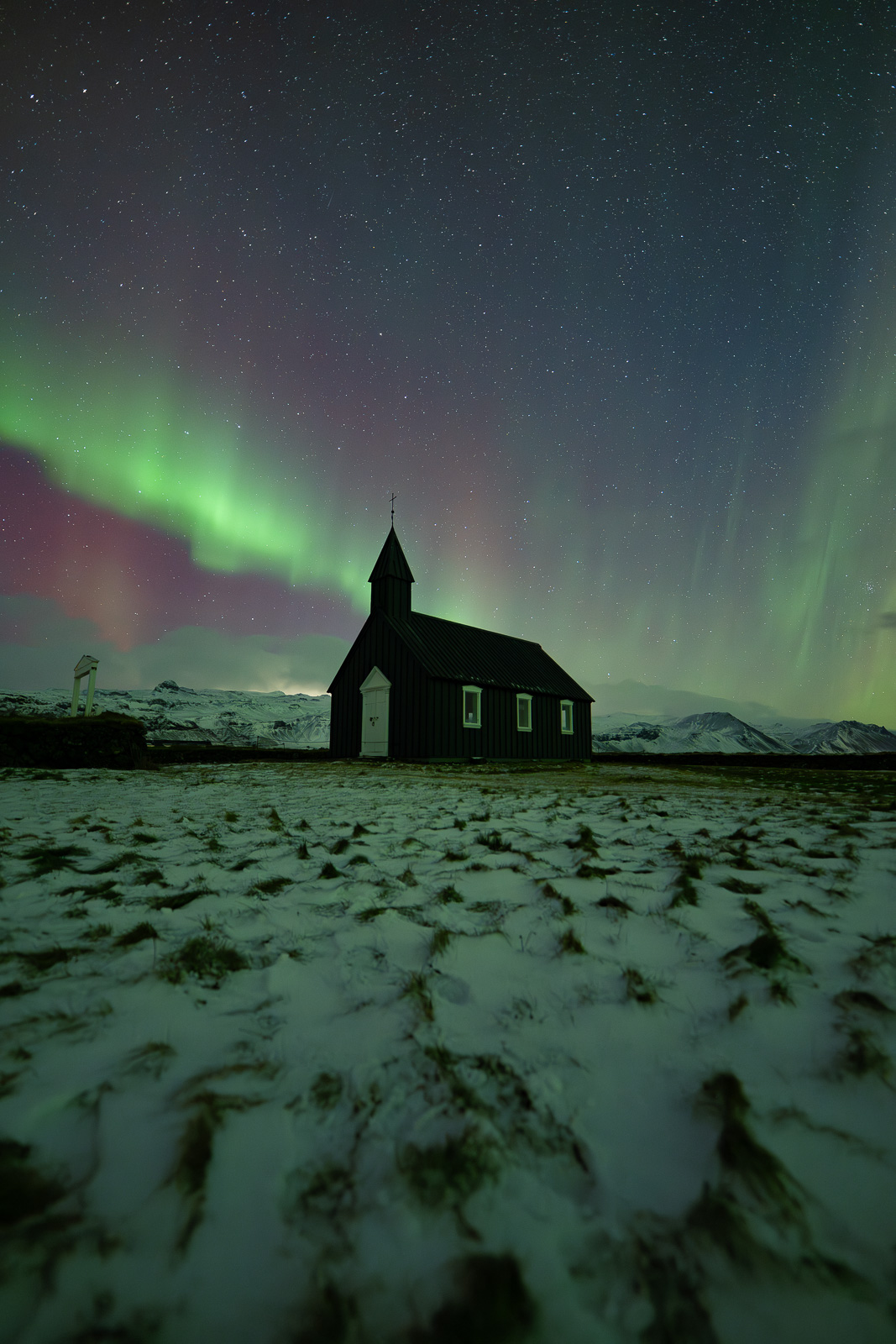 northern lights on Budir black church in Iceland